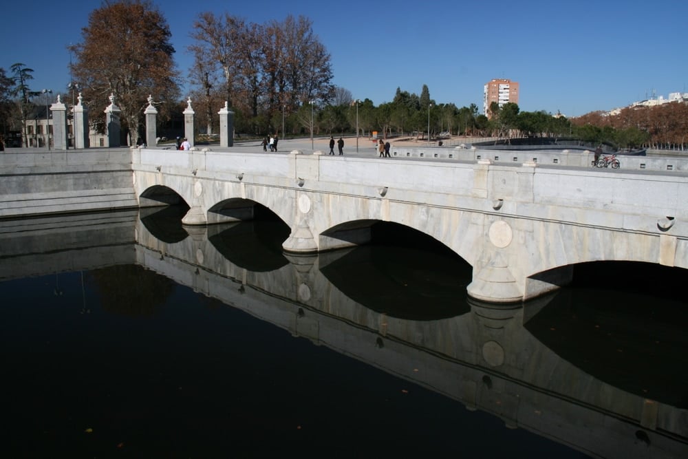Your self-guided walking tour of Madrid will take you across the Puente del Rey towards Casa de Campo Park.