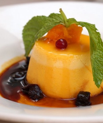 Pumpkin flan (flan de calabaza) decorated with dried fruit and a sprig of mint
