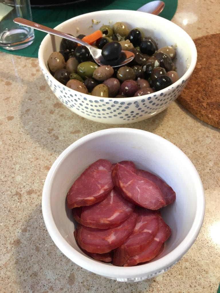 Caldo verde is best accompanied by high-quality chouriço and olives, pictured.