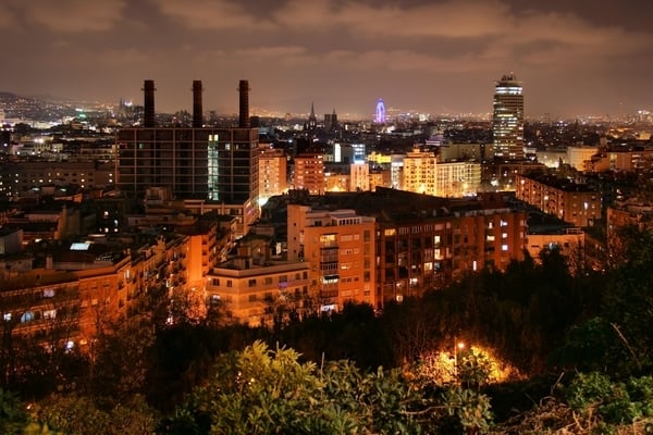 A panoramic view of the Poble Sec neighborhood illuminated at night.