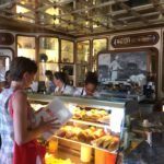 Ordering pastries and coffee on a food tour in Lisbon.