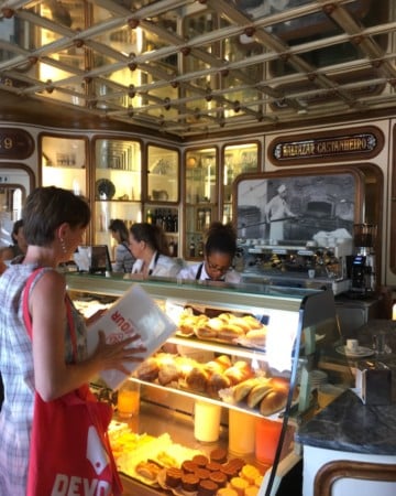 Ordering pastries and coffee on a food tour in Lisbon.