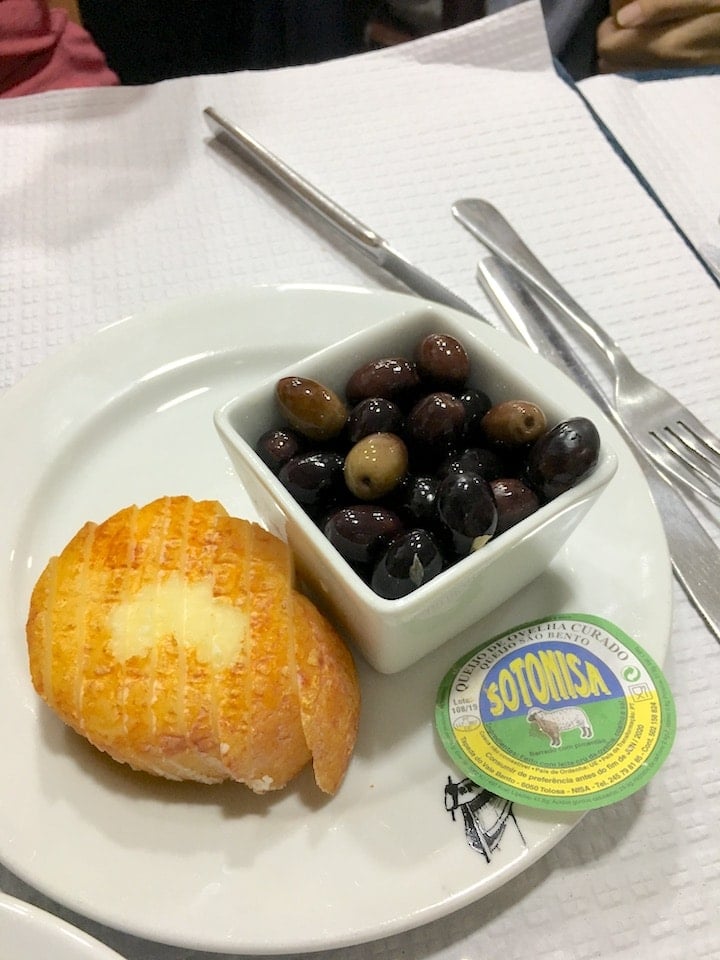 Delicious cheese and olives on a food tour in Lisbon.