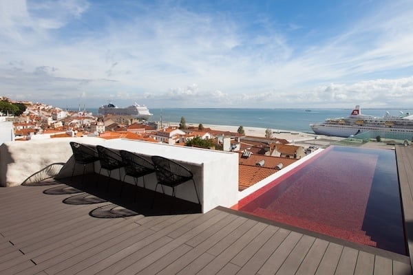 The modern rooftop terrace of Memmo Alfama, with a pool and incredible views of Lisbon.