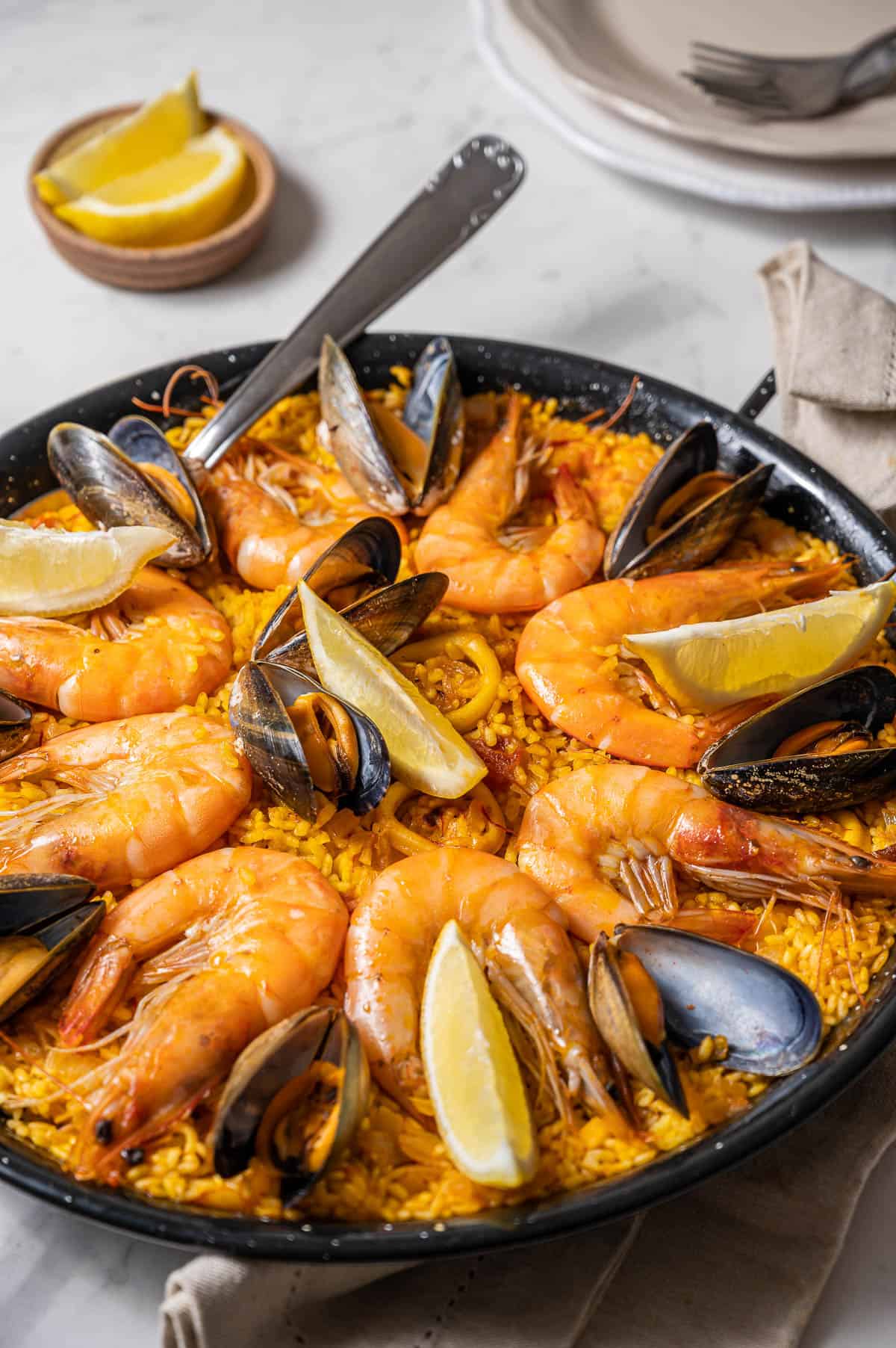 Seafood paella with prawns, mussels, calamari and lemon slices