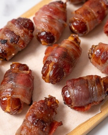 Stuffed Bacon wrapped dates served on a cutting board