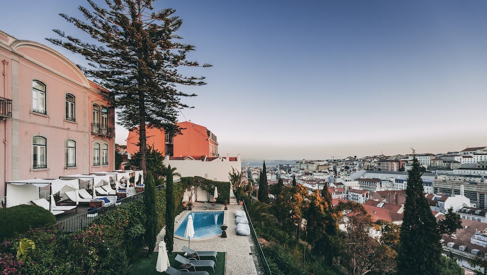 Panoramic view of Lisbon and Torel Palace's scenic terrace with a small swimming pool