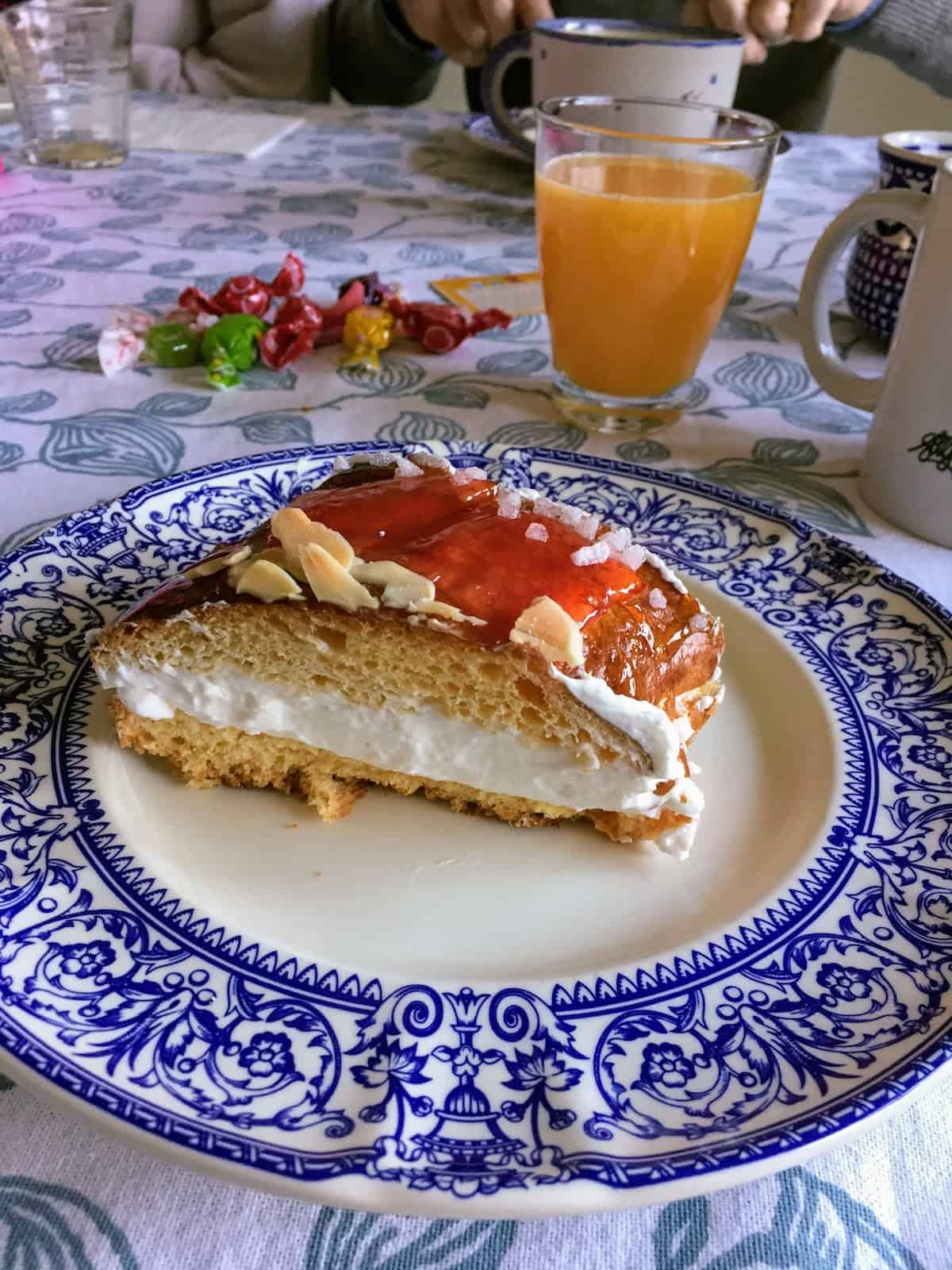 A cream-filled slice of Spanish king cake on a blue and white plate