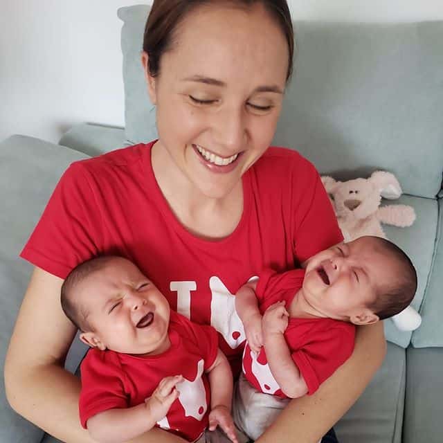 Lauren holding crying twin babies