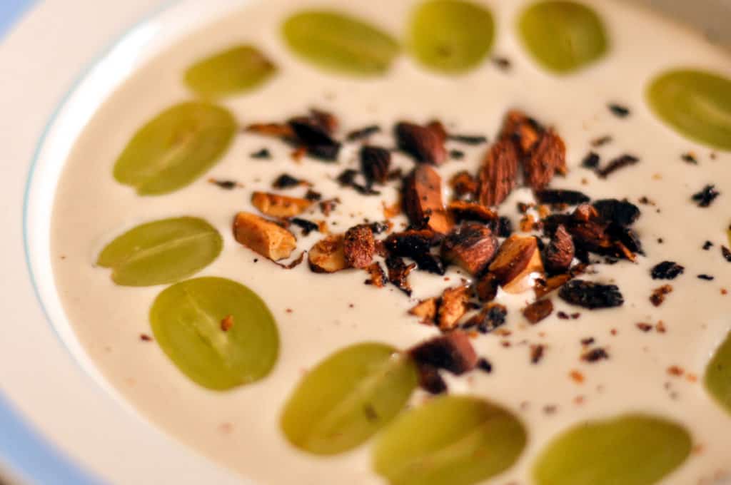 Bowl of cold garlic soup called ajo blanco with different garnishes