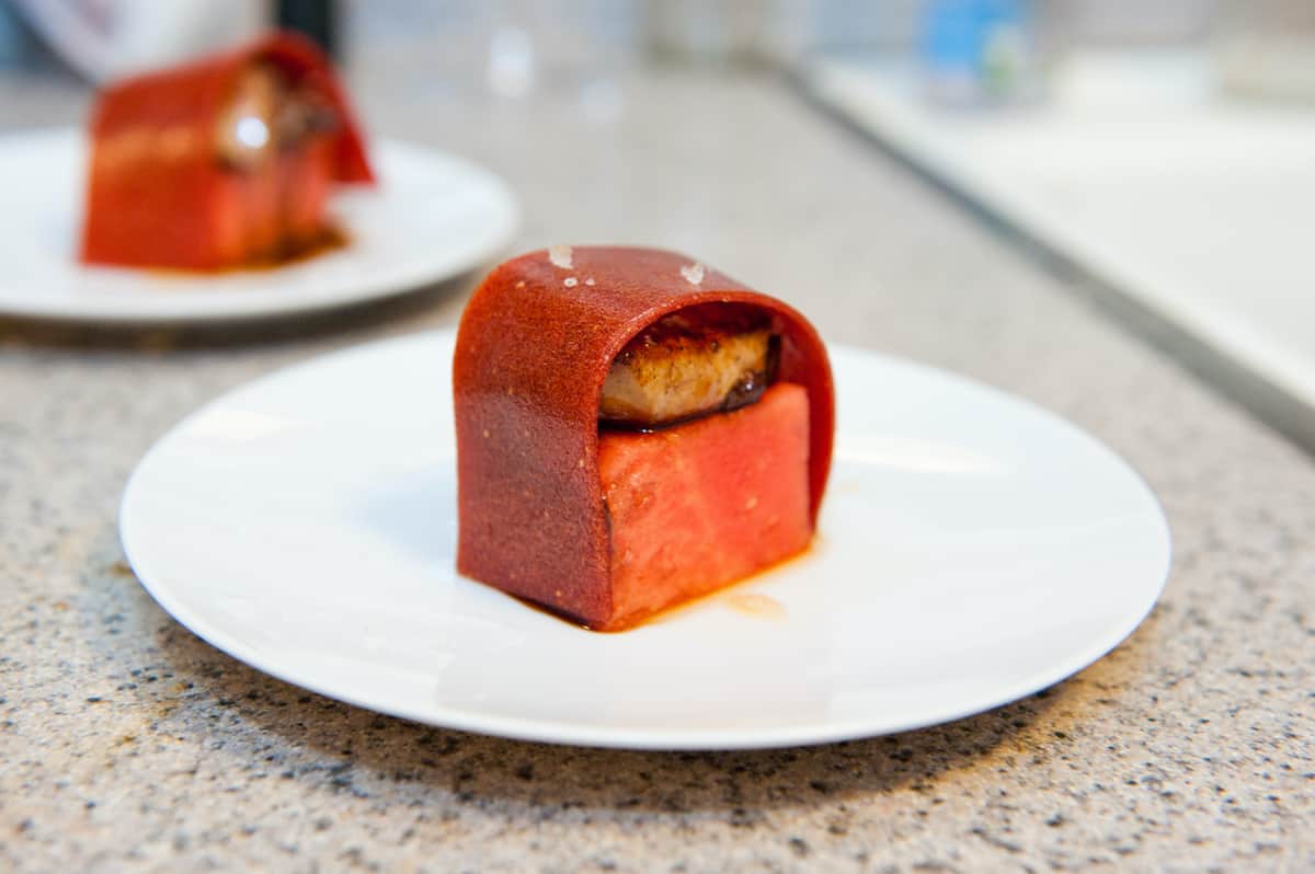 Small bite of food prepared in the molecular gastronomy style on a white plate.