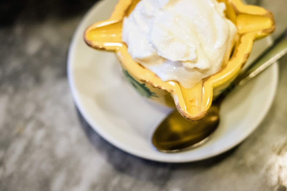 Alioli (garlic mayonnaise) in a yellow serving dish