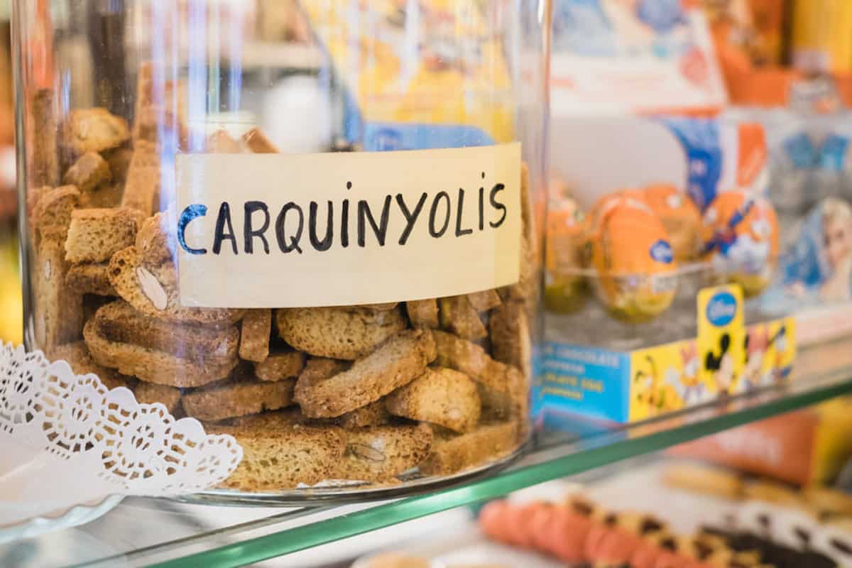 Clear jar of almond cookies labeled "Carquinyolis"