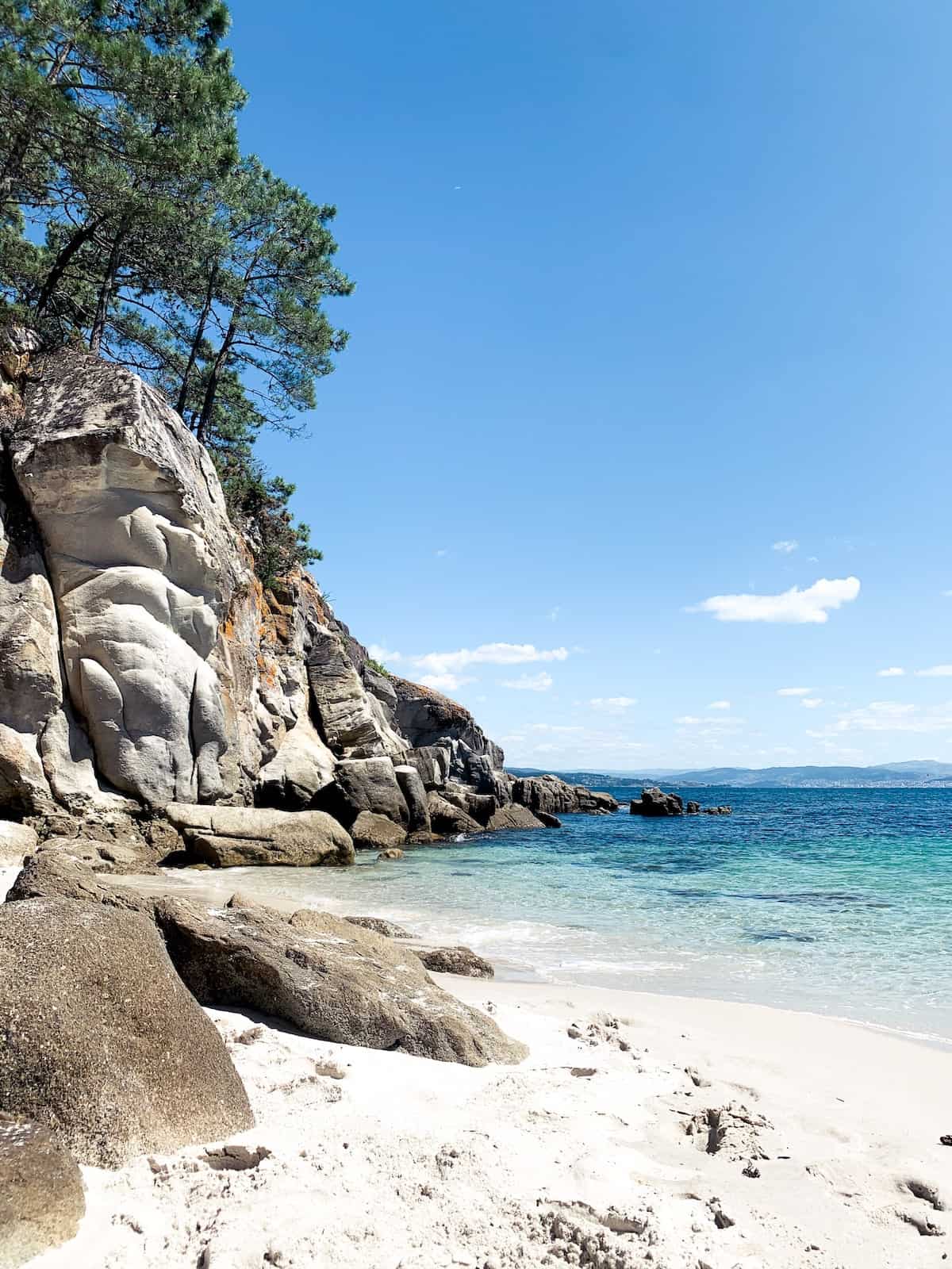 White sand beach surrounded by rocks