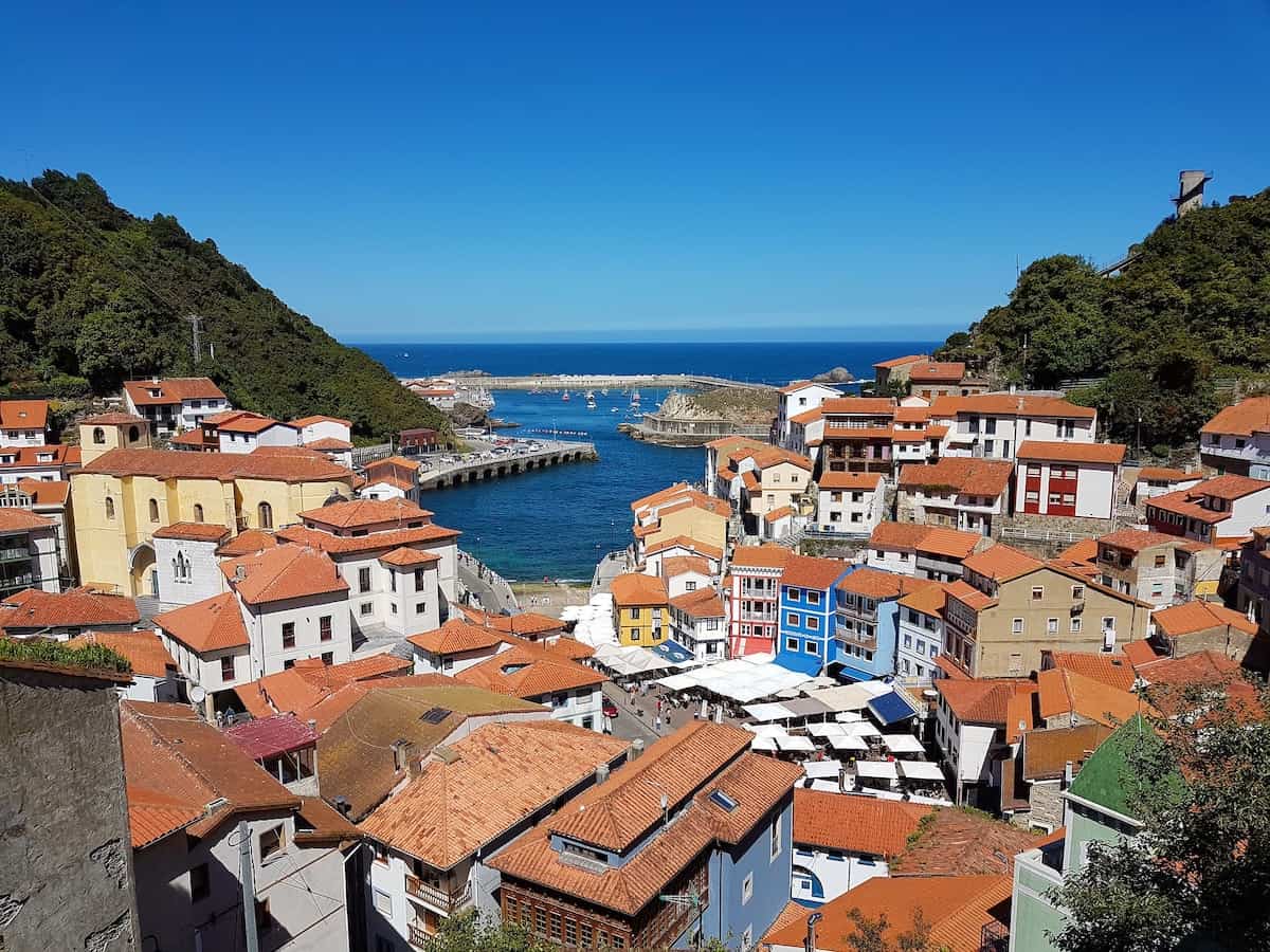 White and blue houses with red tiled roofs overlooking the sea in northern Spain