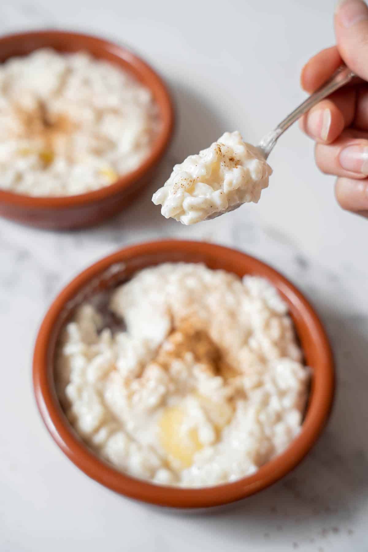 holding a forkful of arroz con leche.