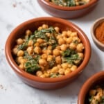 three small bowls of espinacas con garbanzo.