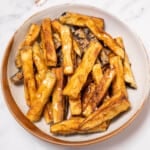 plate of golden fried eggplant drizzled with honey.