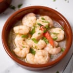 bowl of gambas al ajillo with a red pepper.