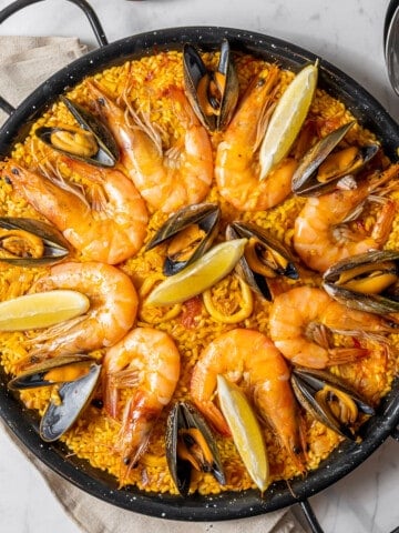 large shallow pan filled with seafood paella.