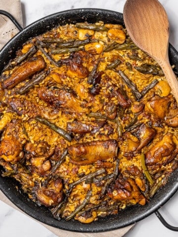 large shallow pan filled with traditional paella.