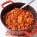 pot of chicken and chorizo stew with a serving spoon.