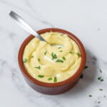 bowl of garlic alioli with a spoon.