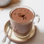 a cup of Spanish hot chocolate with a spoon on a saucer.