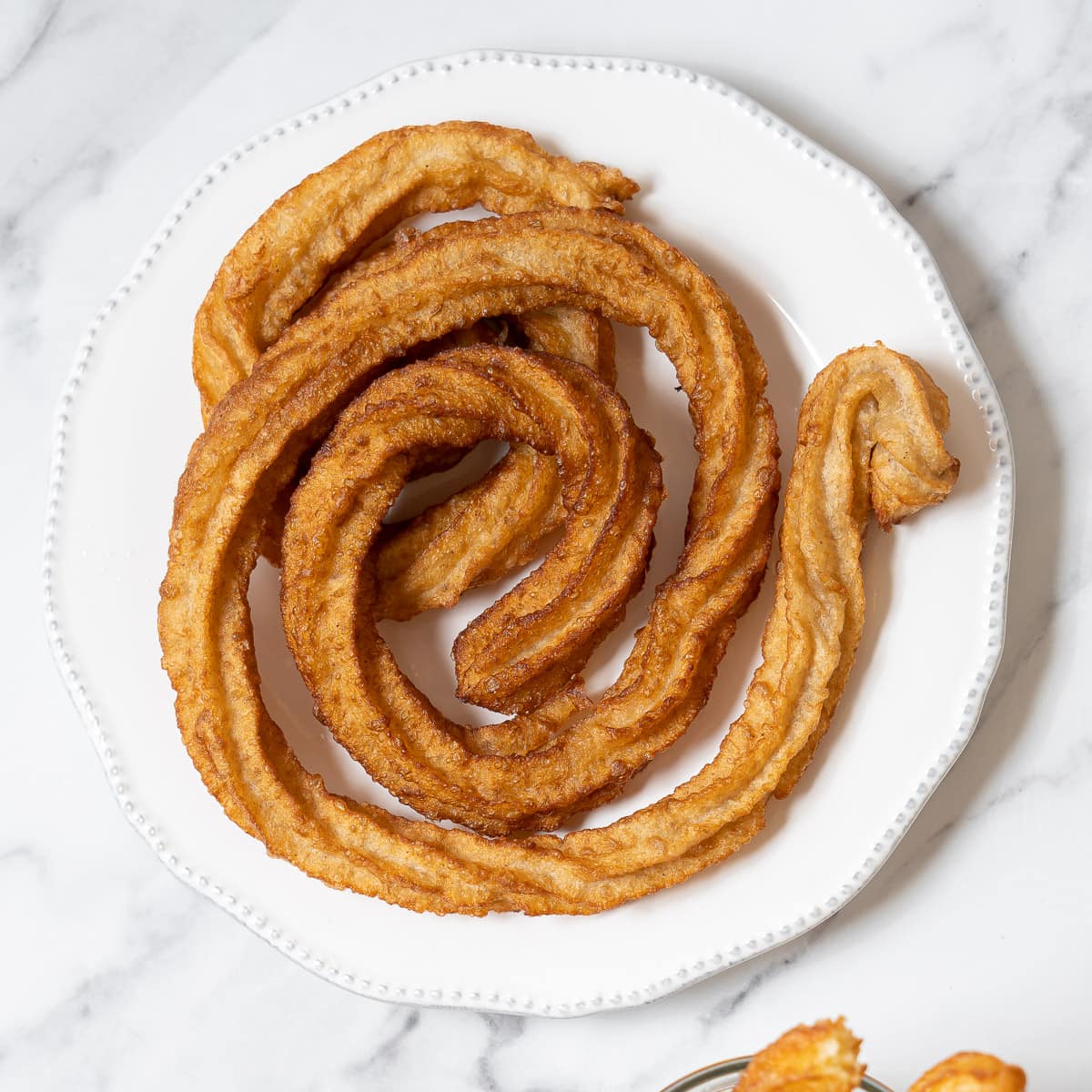 https://spanishsabores.com/wp-content/uploads/2023/11/Churros-Featured-1.jpg