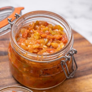 jar of Spanish sofrito on a wooden cutting board.