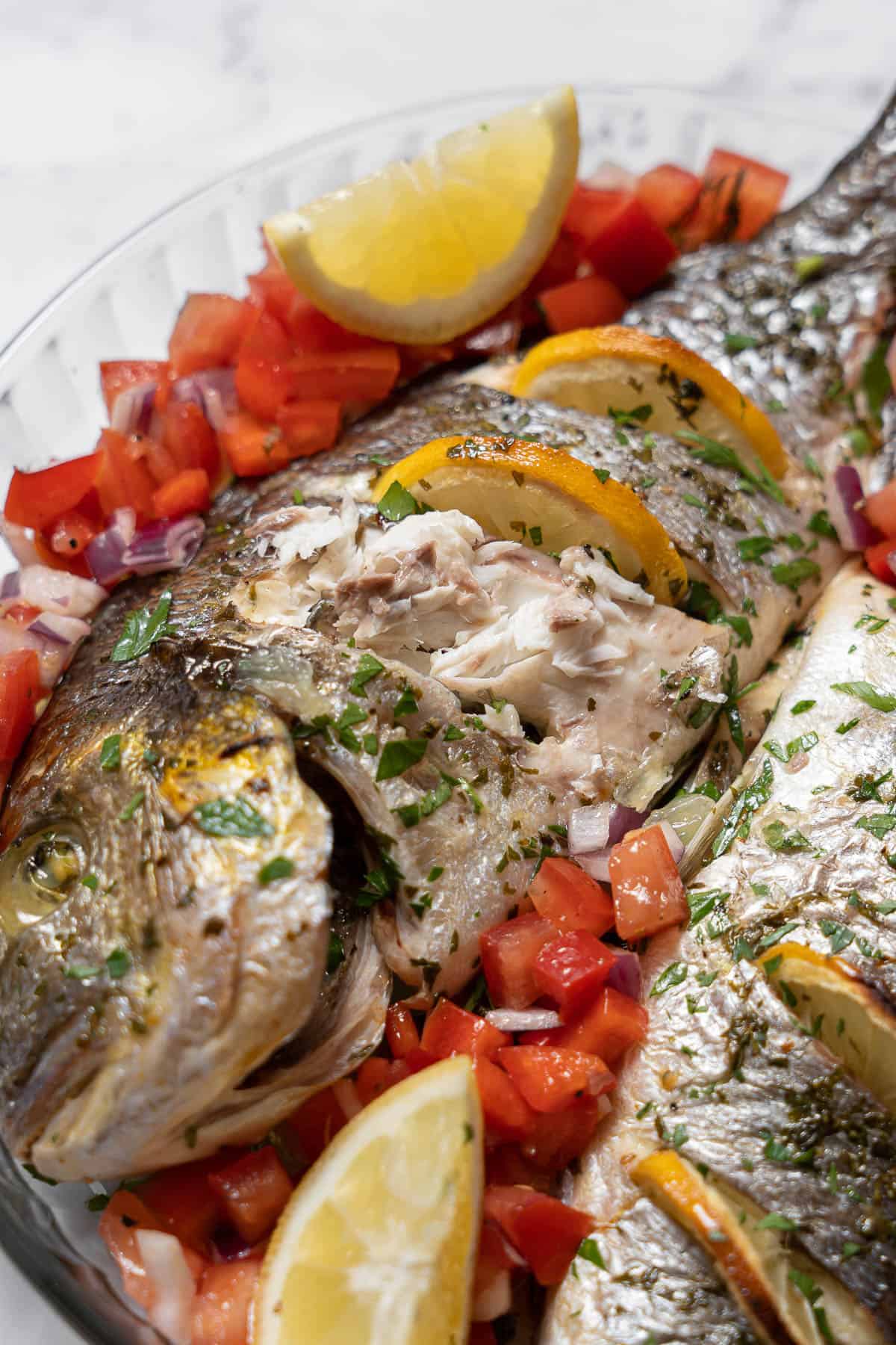 flaky baked bream with tomato salad.