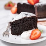slice of chocolate olive oil cake with a strawberry.