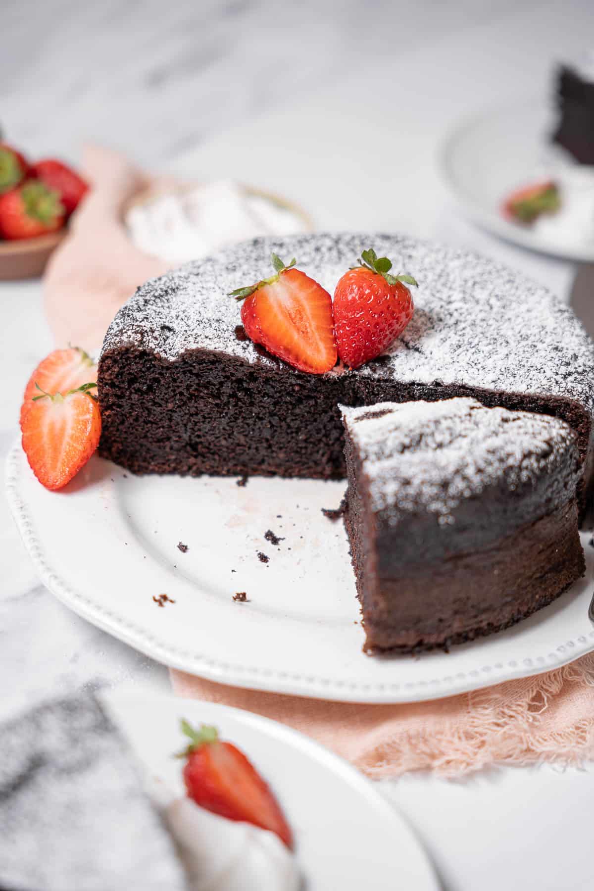 chocolate olive oil cake sliced with strawberries.