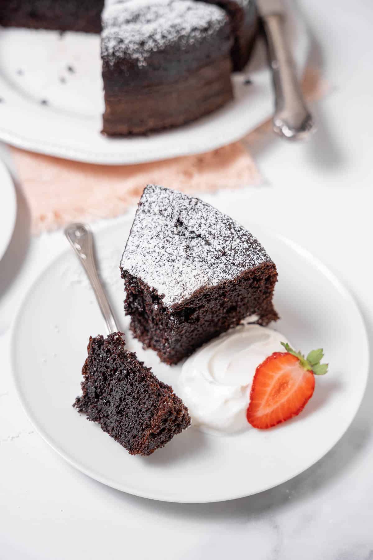 slice of chocolate olive oil cake with a strawberry.