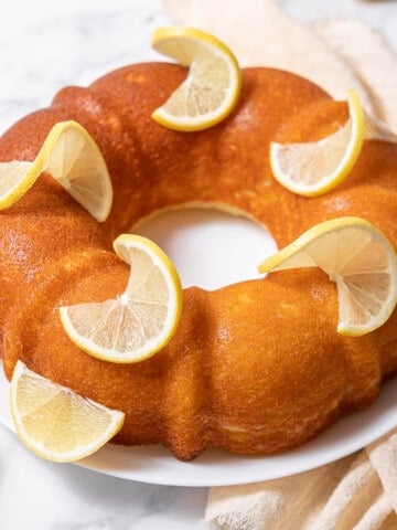 lemon yogurt cake decorated with lemon slices.