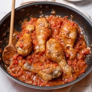 pan of chicken with tomatoes.