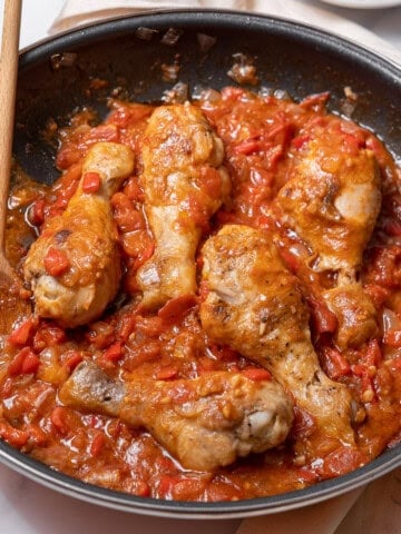 pan of chicken with tomatoes.