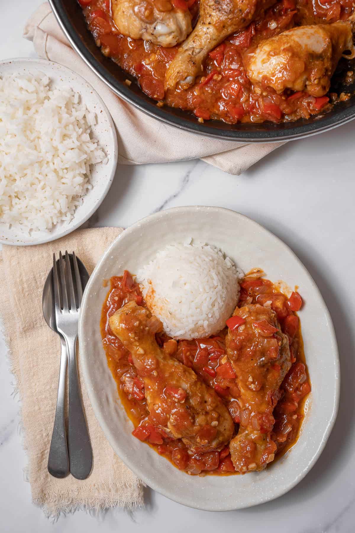 chicken with tomatoes served with rice.
