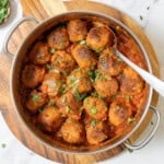 pan of Spanish meatballs with a serving spoon.