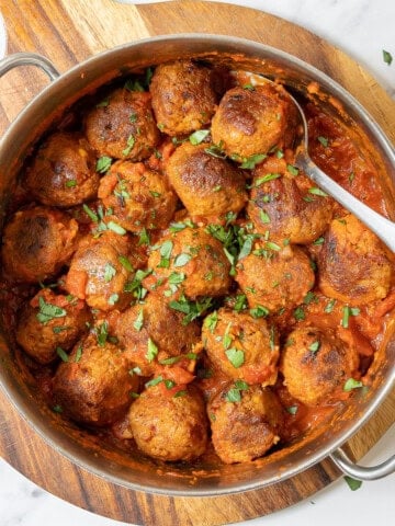 pan of Spanish meatballs with a serving spoon.