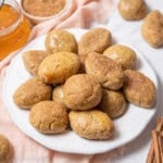 plate of broas de mel with cinnamon sticks.