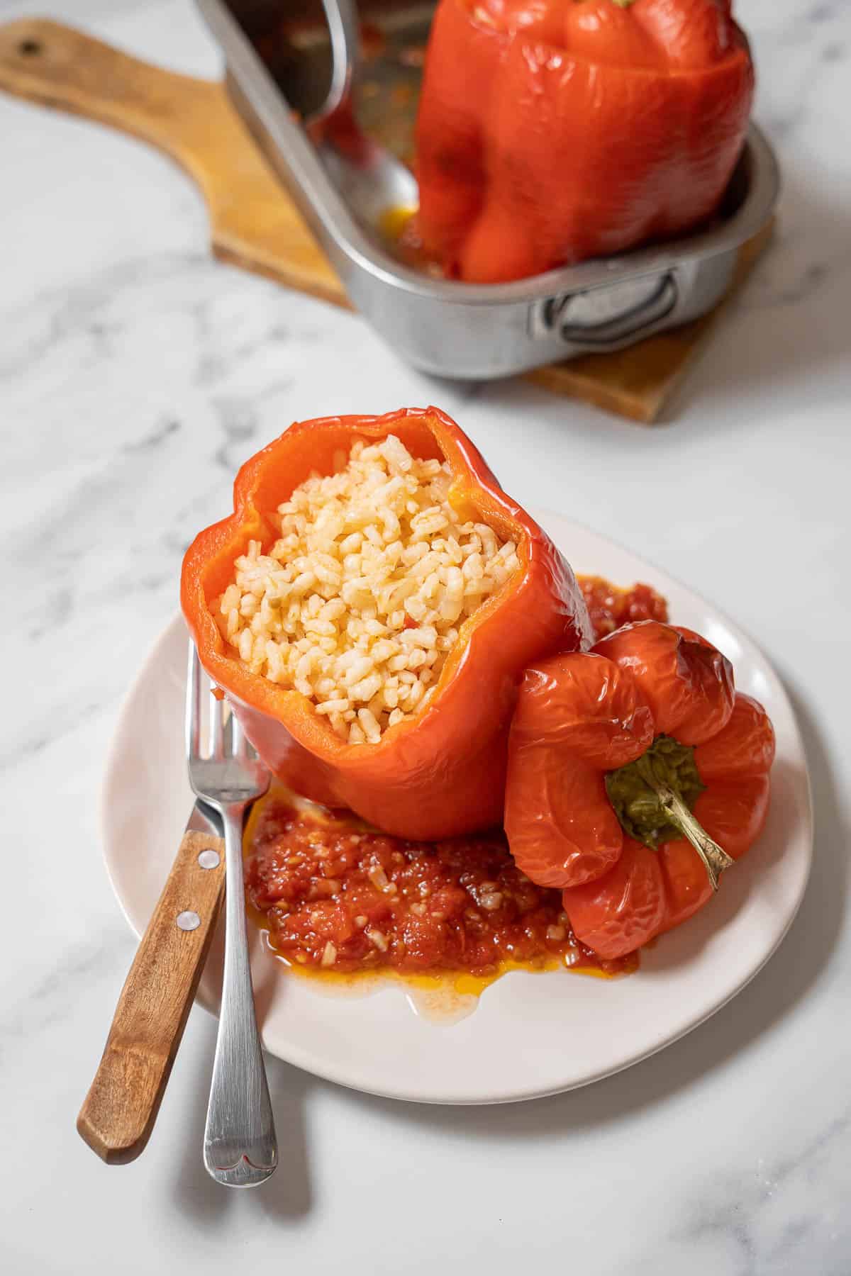 Spanish stuffed pepper with a fork and knife.