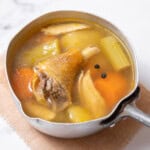 saucepan filled with caldo de pollo.