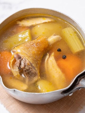 saucepan filled with caldo de pollo.