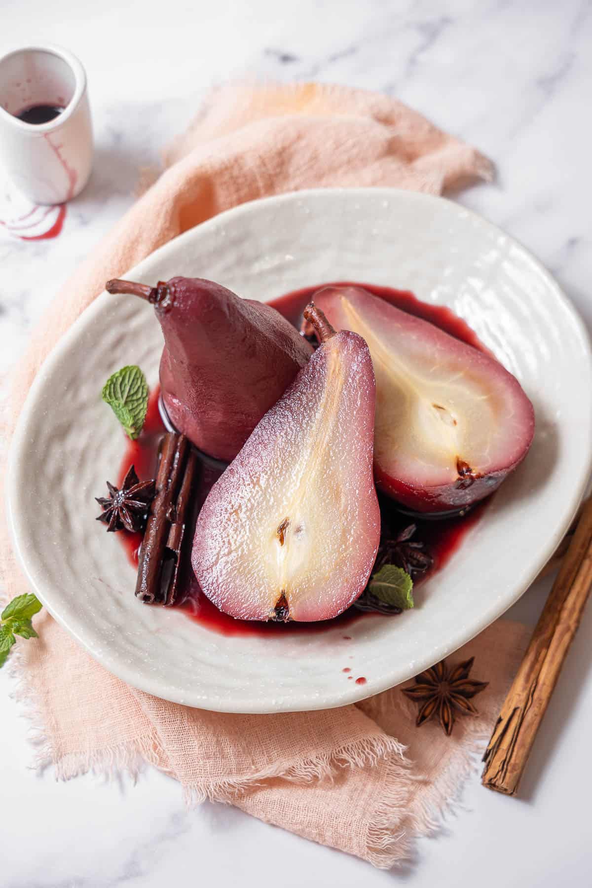 dish of poached pears in red wine.