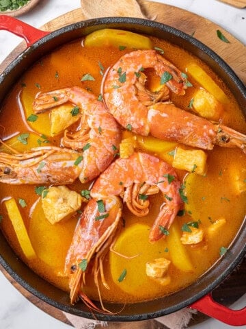 pot of Catalan fish stew on a board.