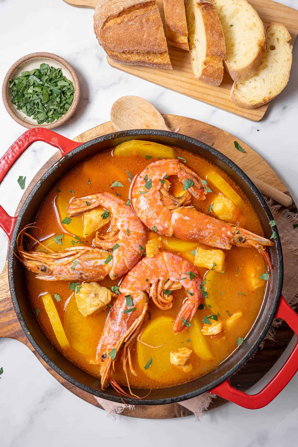 pot of Catalan fish stew with fresh bread.