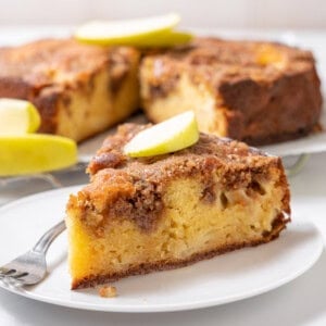 slice of apple olive oil cake on a plate.