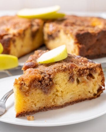 slice of apple olive oil cake on a plate.