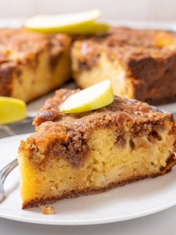 slice of apple olive oil cake on a plate.